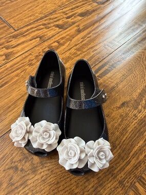 Mini Melissa Black Glitter Mary Janes with White Flower Appliqués